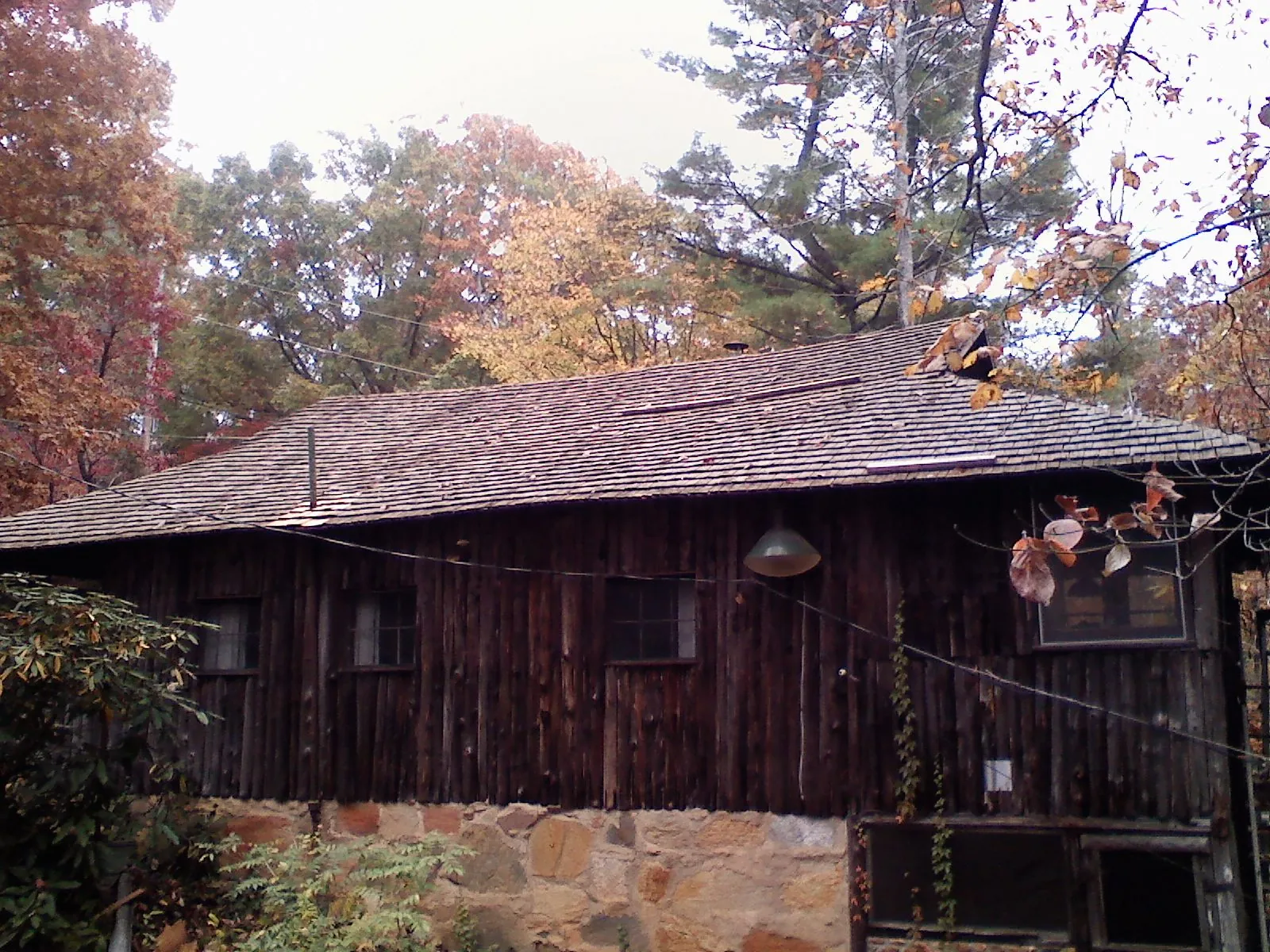 Weathered wood shake roof on a rustic board sided cabin in Grantville
