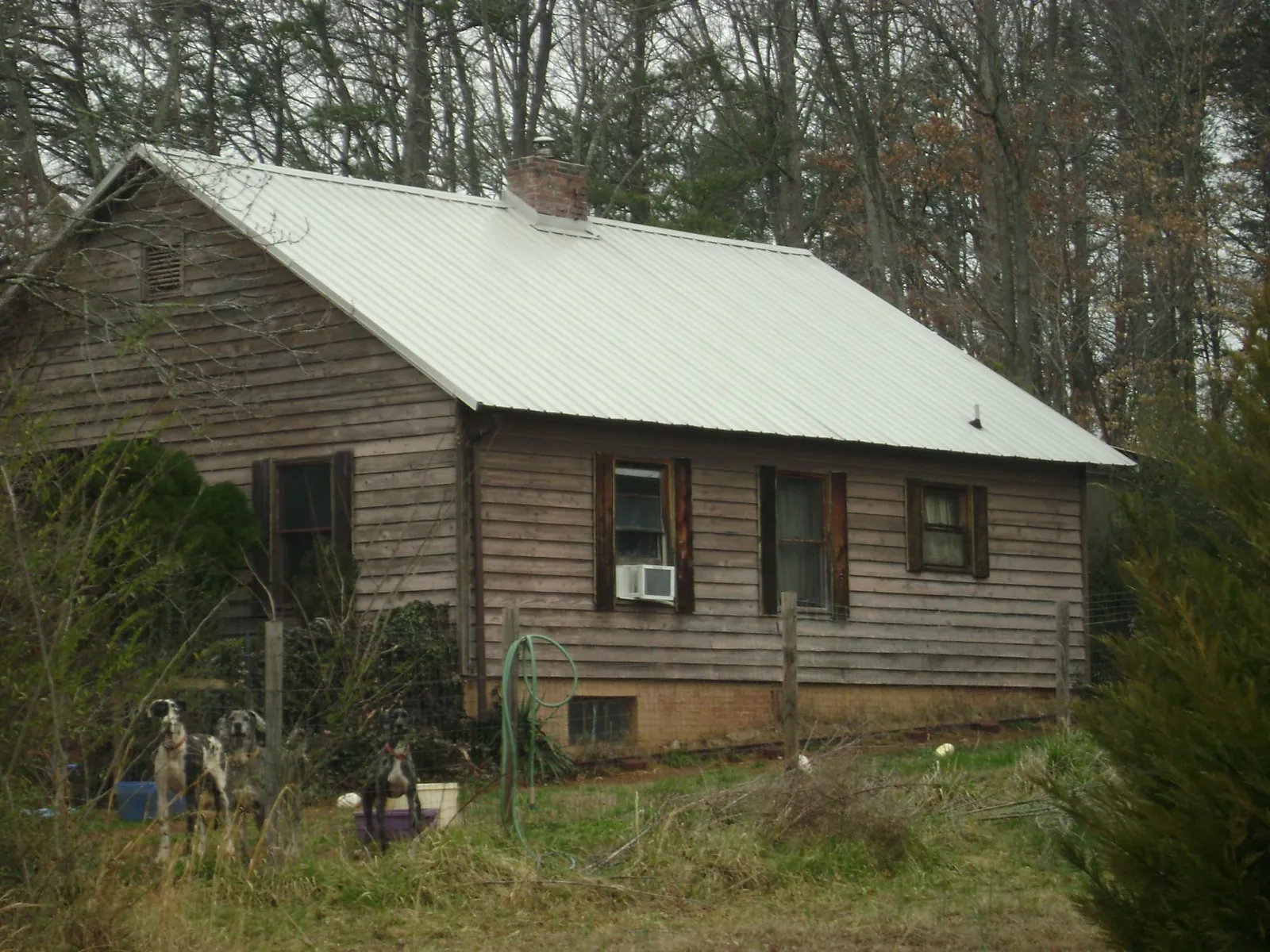 White metal roof on an old wood sided farmhouse, from a Metal Roof Installation job in Grantville